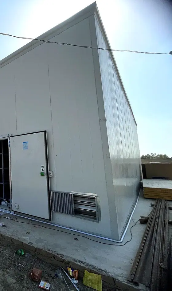 A finished MushroomWale grow-room block: PUF panel walls and the insulated door