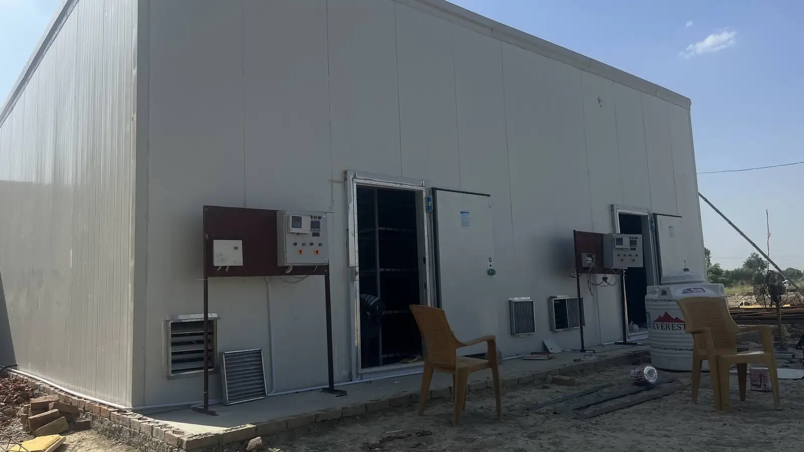A finished MushroomWale PUF panel grow room with its door, controller and cooling units