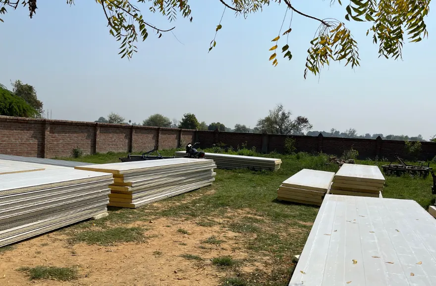 80mm PPGL PUF panels stacked on a MushroomWale site before erection